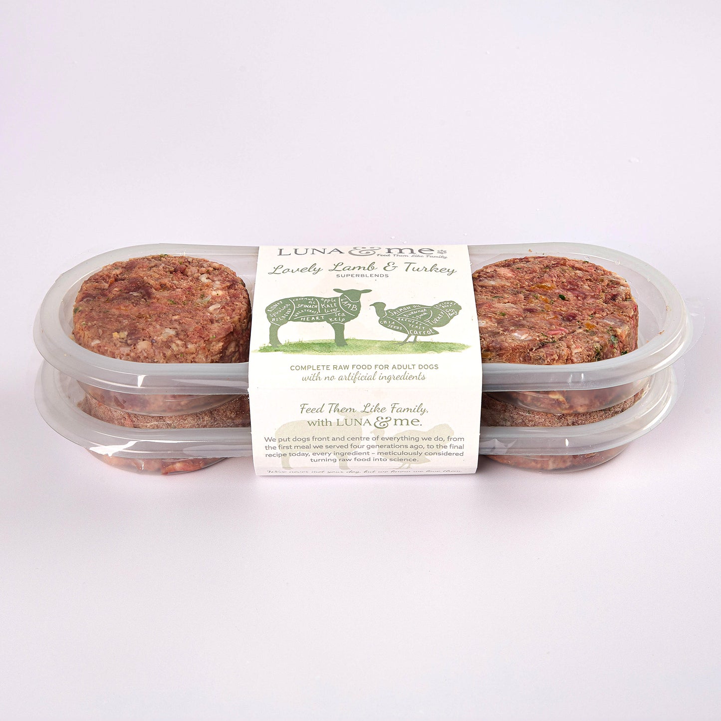 Two stacked plastic containers filled with LUNA & me Lovely Lamb & Turkey raw dog food patties