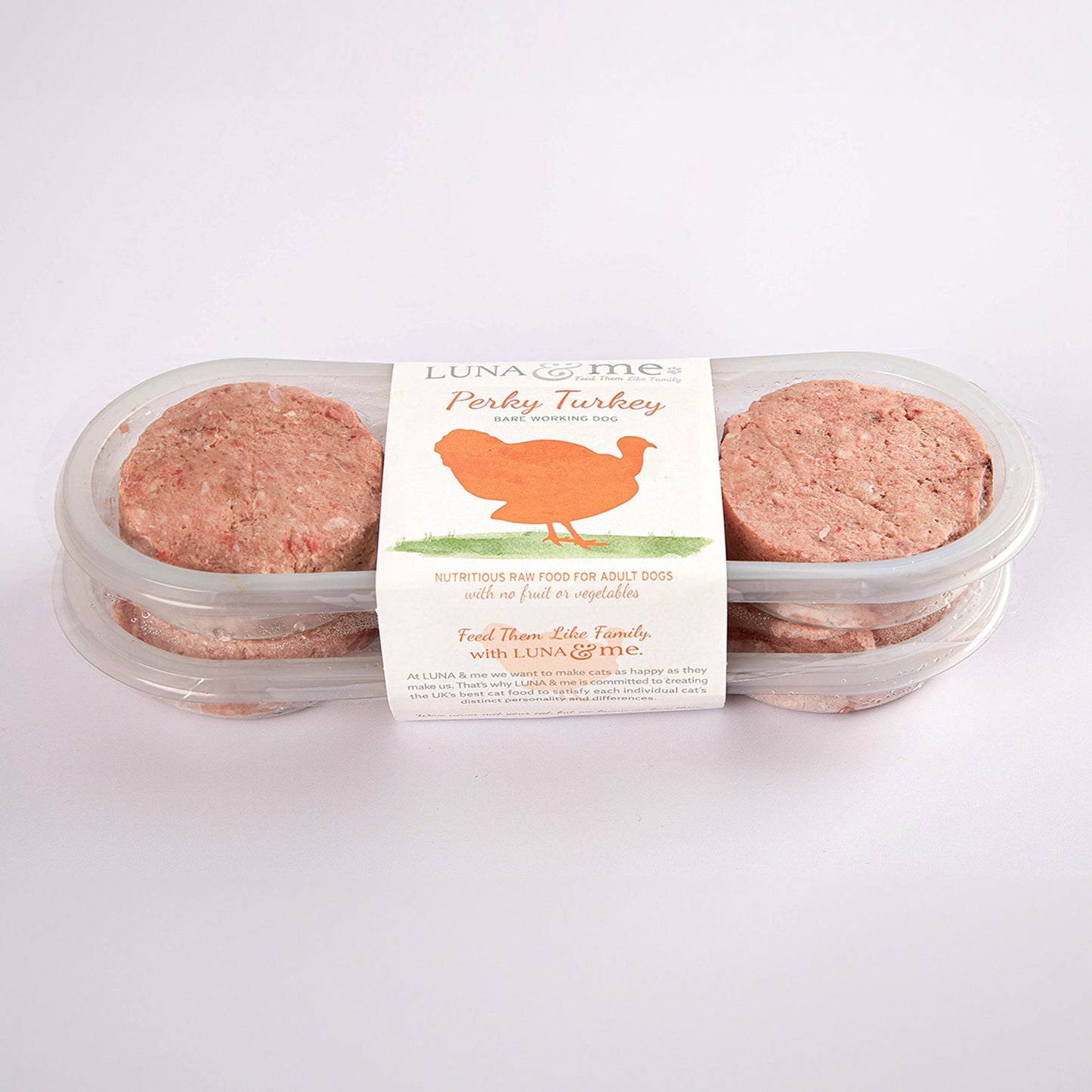 Two stacked plastic containers filled with LUNA & me Perky Turkey raw dog food patties