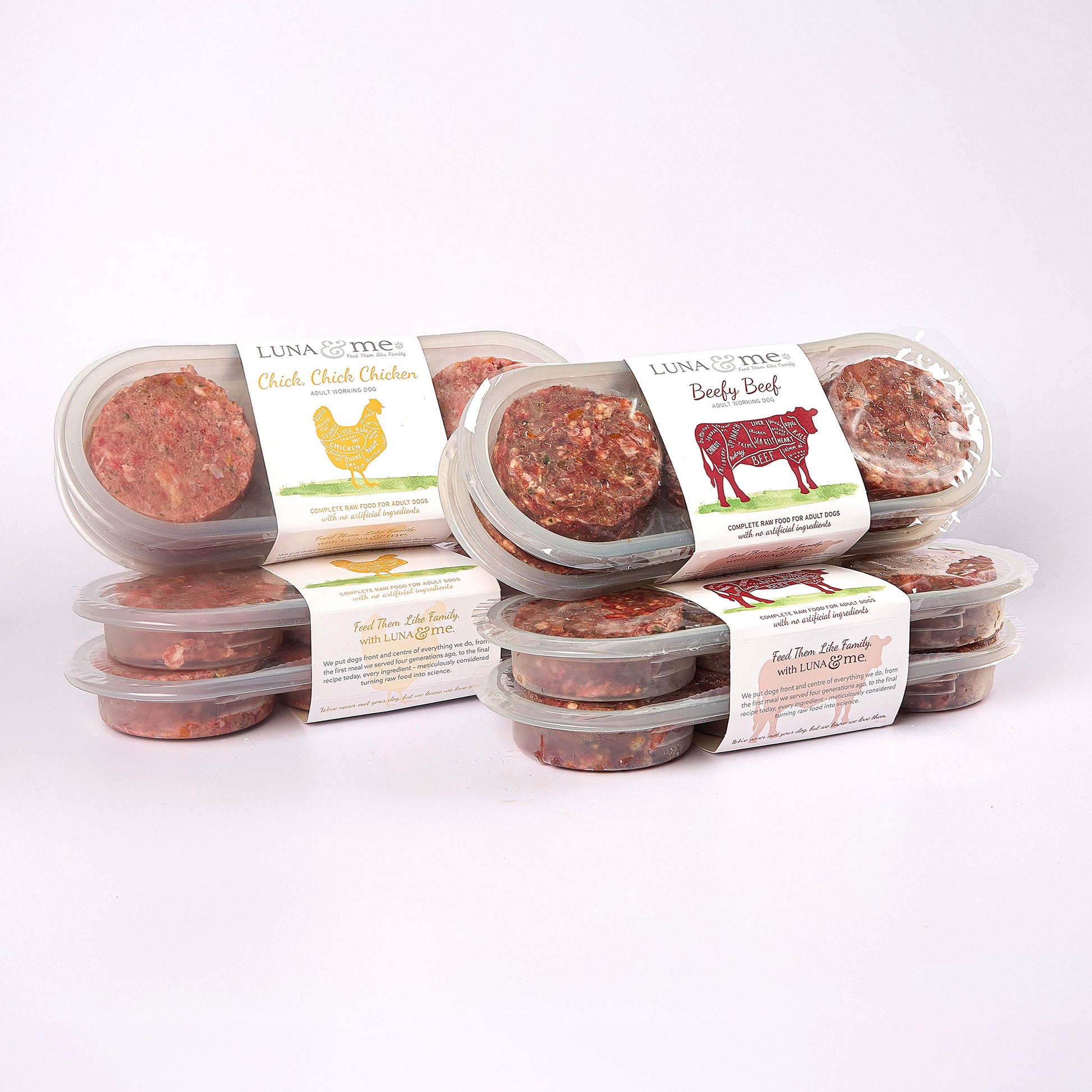 Four stacked plastic containers filled with LUNA & me Weekly Favourites raw dog food patties